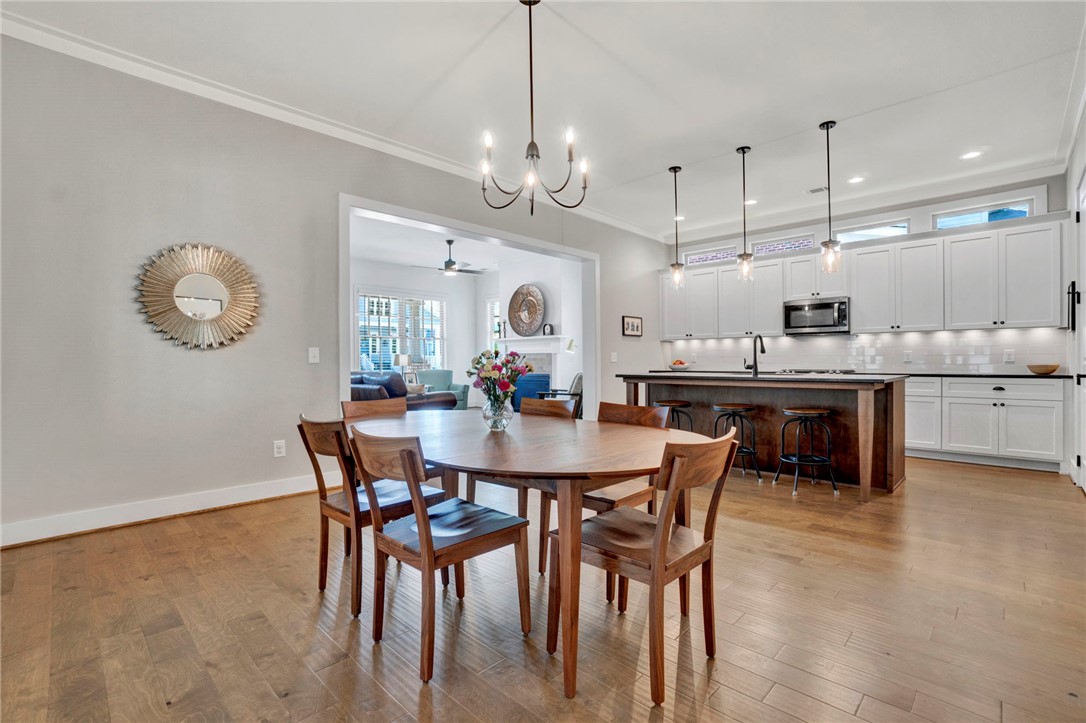 308 Pershing Avenue Clemson, SC 29631 - Photo 7 of 31 This open concept space features a kitchen island and elegant hardwood flooring throughout the dining area.
