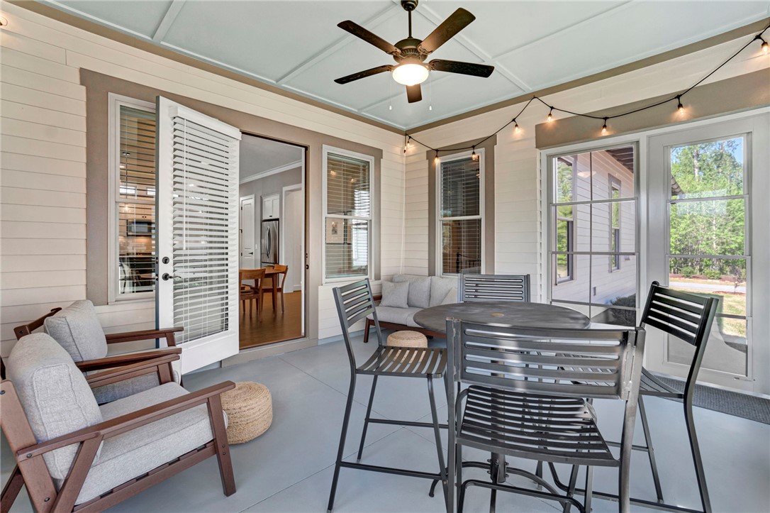 308 Pershing Avenue Clemson, SC 29631 - Photo 10 of 31 This inviting porch offers a perfect spot for relaxation and outdoor dining, blending seamlessly with the interior.