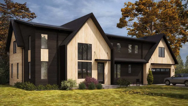 a view of a house with large windows and a yard