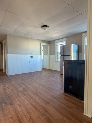 a view of a kitchen with a sink and a refrigerator