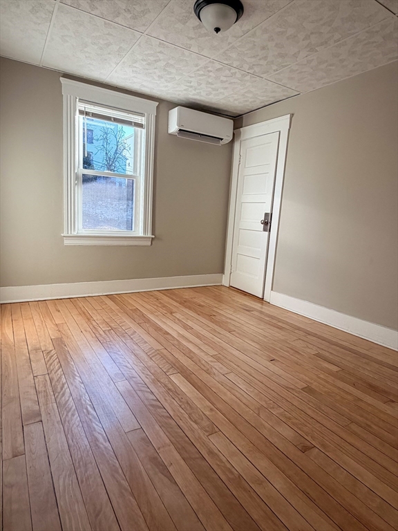 4 Vernon Terrace, Unit 2 Worcester, MA 01610 - Photo 6 of 12 a view of an empty room with wooden floor and a window