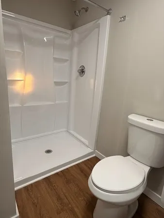 a bathroom with a toilet and a shower