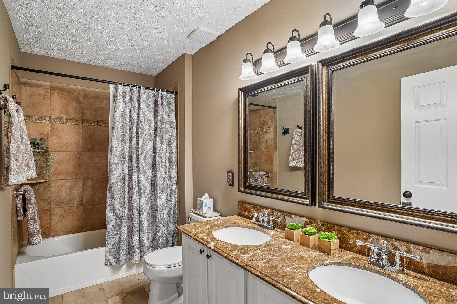 217 Raccoon Run Court Hanover, MD 21076 - Photo 23 of 38 a bathroom with a granite countertop sink toilet and shower