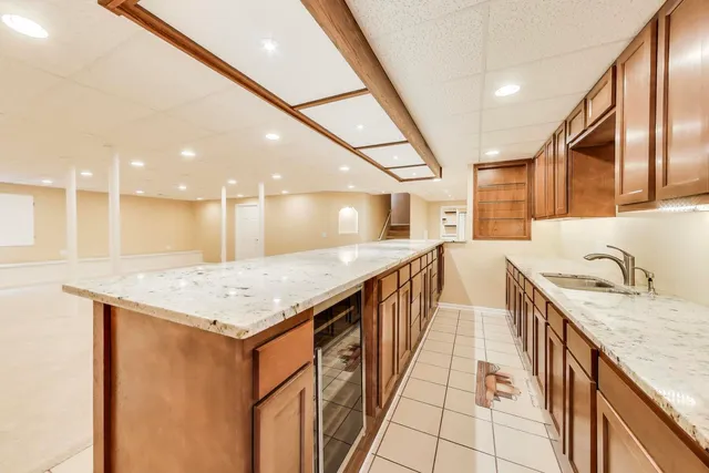 a kitchen with a sink and a wooden floor