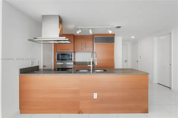a view of a kitchen with cabinets and wooden floor