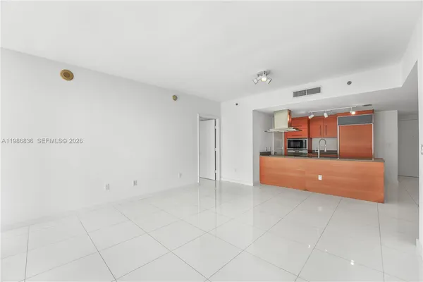 a large bathroom with a tub and mirror