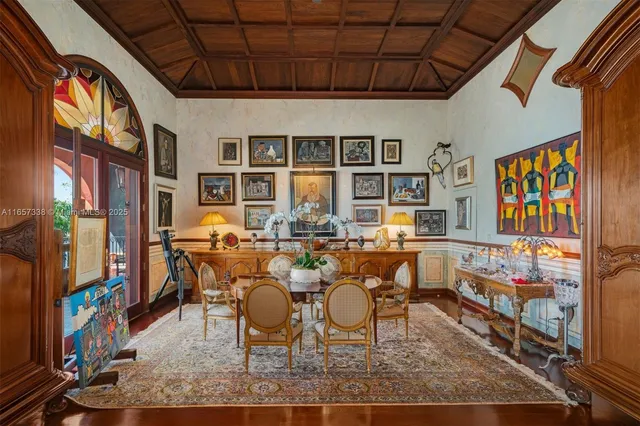 a view of a dining room with furniture a rug and wooden floor