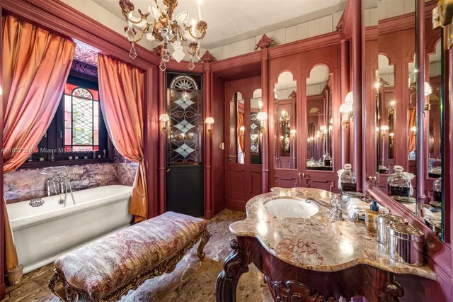 a view of pool with lawn chairs under an umbrella