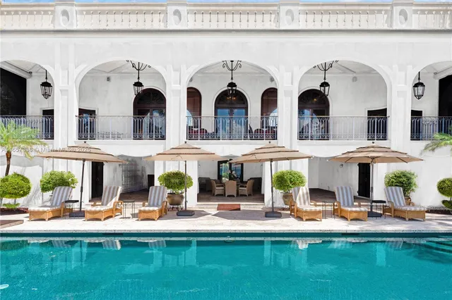 a view of multiple house with swimming pool and chairs