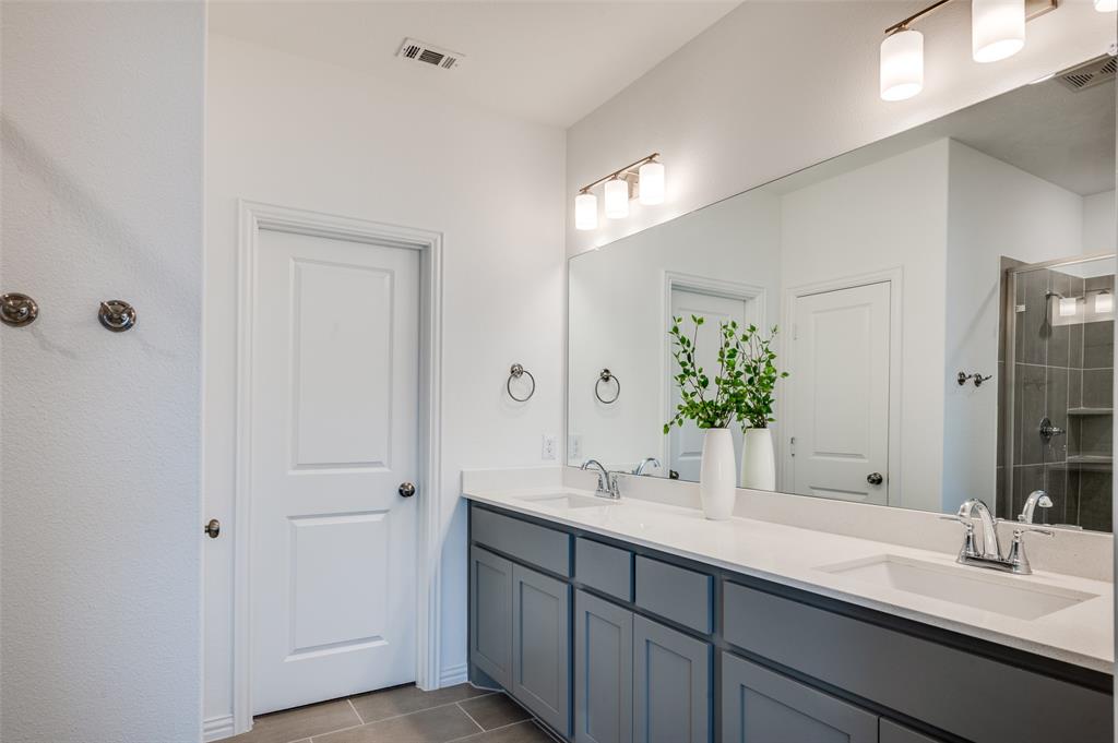 3718 Pelican Rst Way Arlington, TX 76005 - Photo 14 of 37 a bathroom with double vanity sinks and a mirror