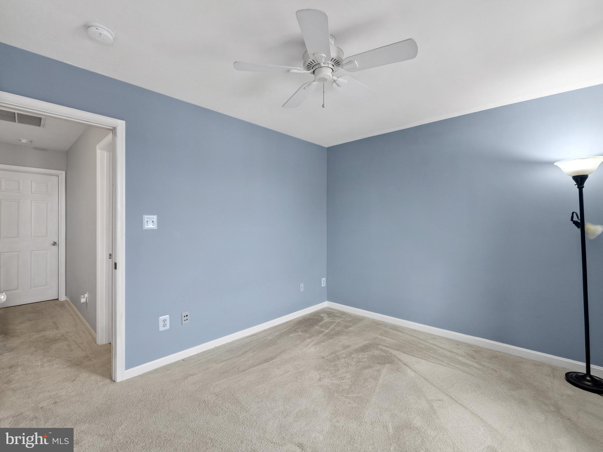 45458 Bluemont Junction Square Sterling, VA 20164 - Photo 20 of 24 an empty room with a ceiling fan and a window