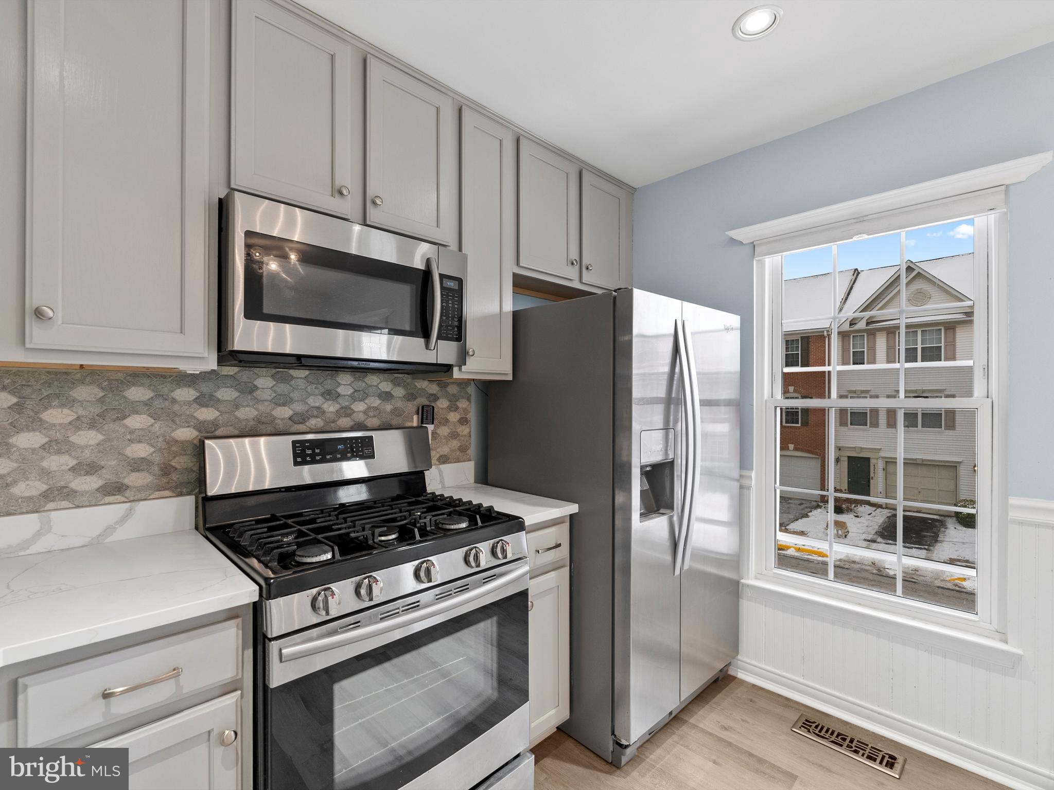 45458 Bluemont Junction Square Sterling, VA 20164 - Photo 6 of 24 a kitchen with stainless steel appliances a stove a microwave and a refrigerator