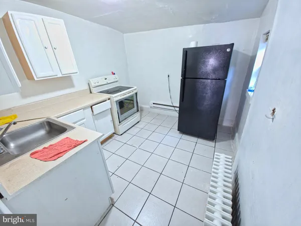 a kitchen that has a sink and a stove in it