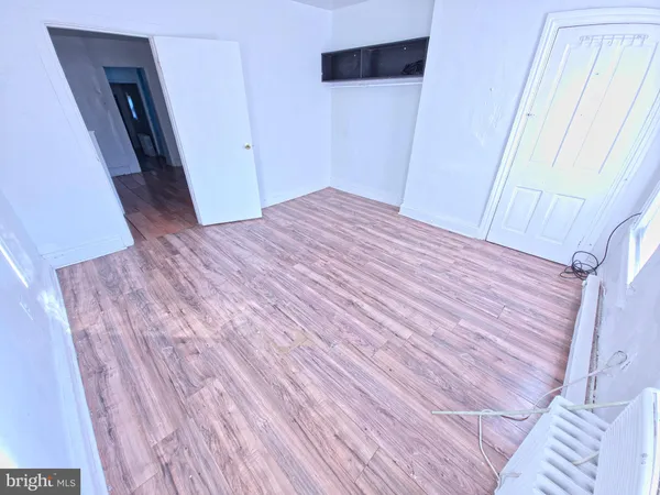 a view of a room with wooden floor and furniture