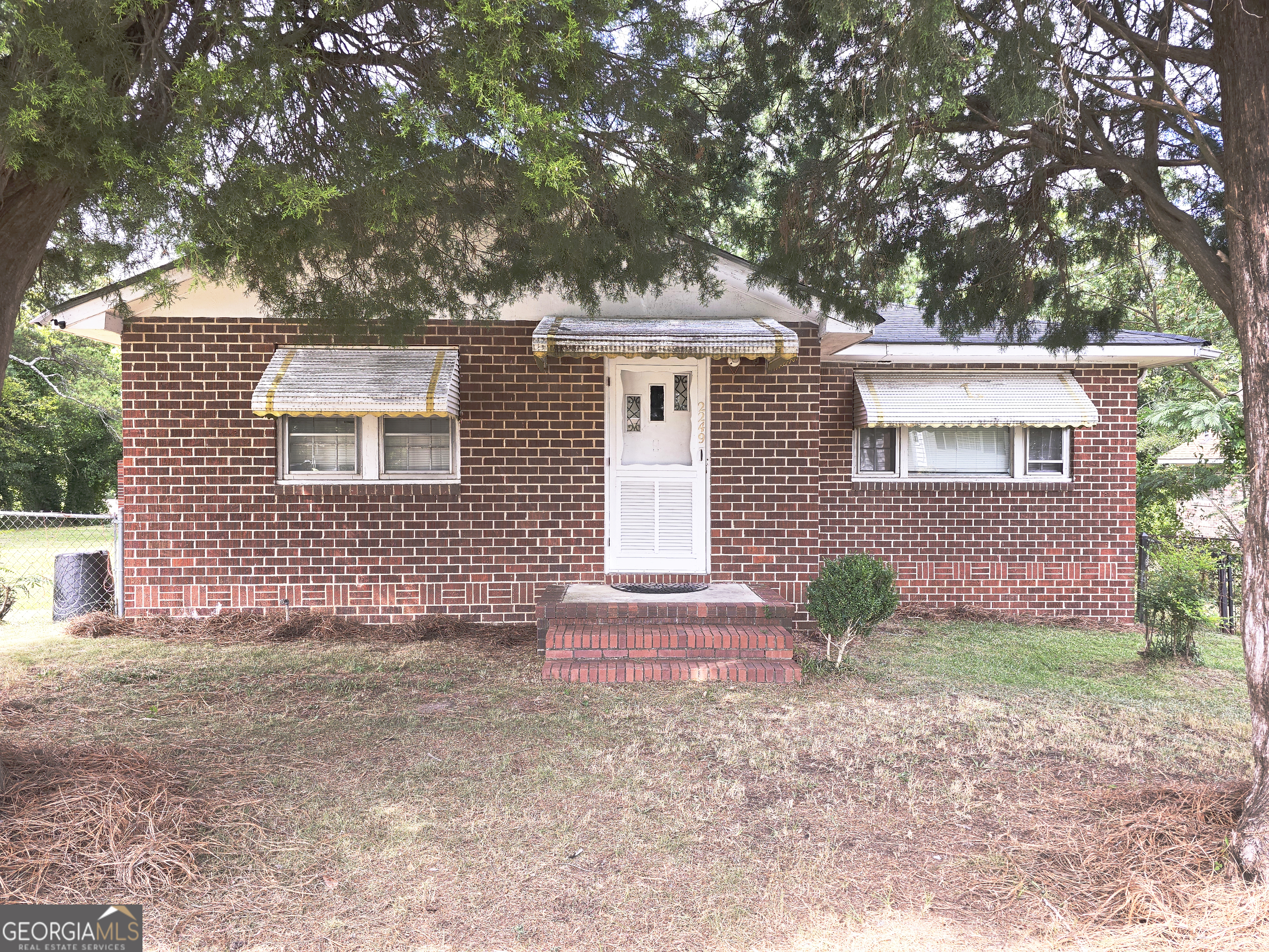 2249 Lowe Street Macon, GA 31206 - Photo 1 of 17 a front view of a house with a yard and a garage