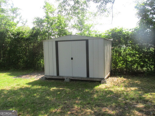 625 Strickland Road Locust Grove, GA 30248 - Photo 10 of 11 a view of backyard with large tree and wooden fence