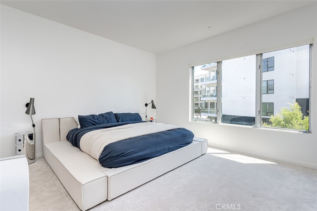 21 Gramercy, Unit 306 Irvine, CA 92612 - Photo 15 of 46 a spacious bedroom with a bed and window