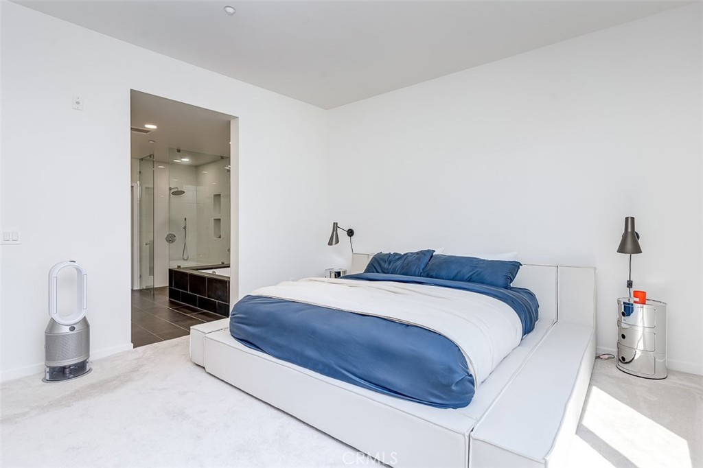 21 Gramercy, Unit 306 Irvine, CA 92612 - Photo 16 of 46 a bedroom with a bed and a chandelier