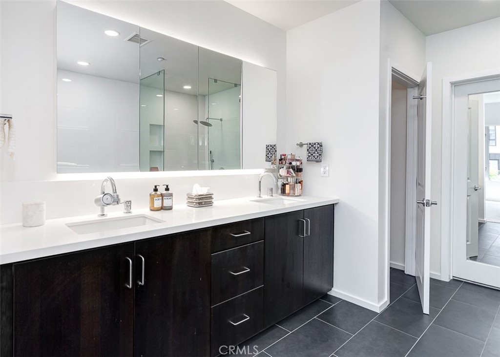 21 Gramercy, Unit 306 Irvine, CA 92612 - Photo 18 of 46 a bathroom with a double vanity sink a mirror and a
