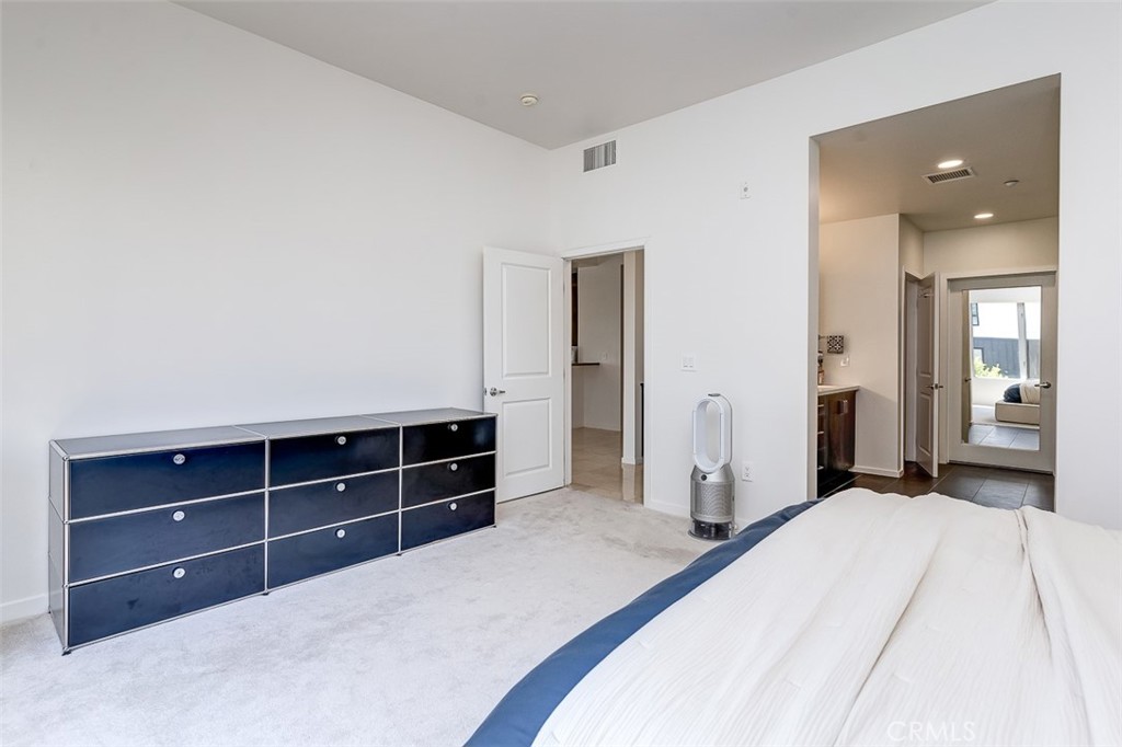 21 Gramercy, Unit 306 Irvine, CA 92612 - Photo 19 of 46 a bedroom with a bed and a dresser