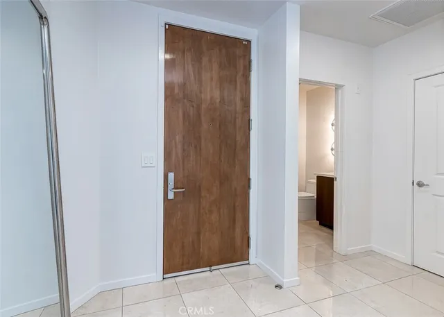 a bathroom with a toilet sink vanity and mirror