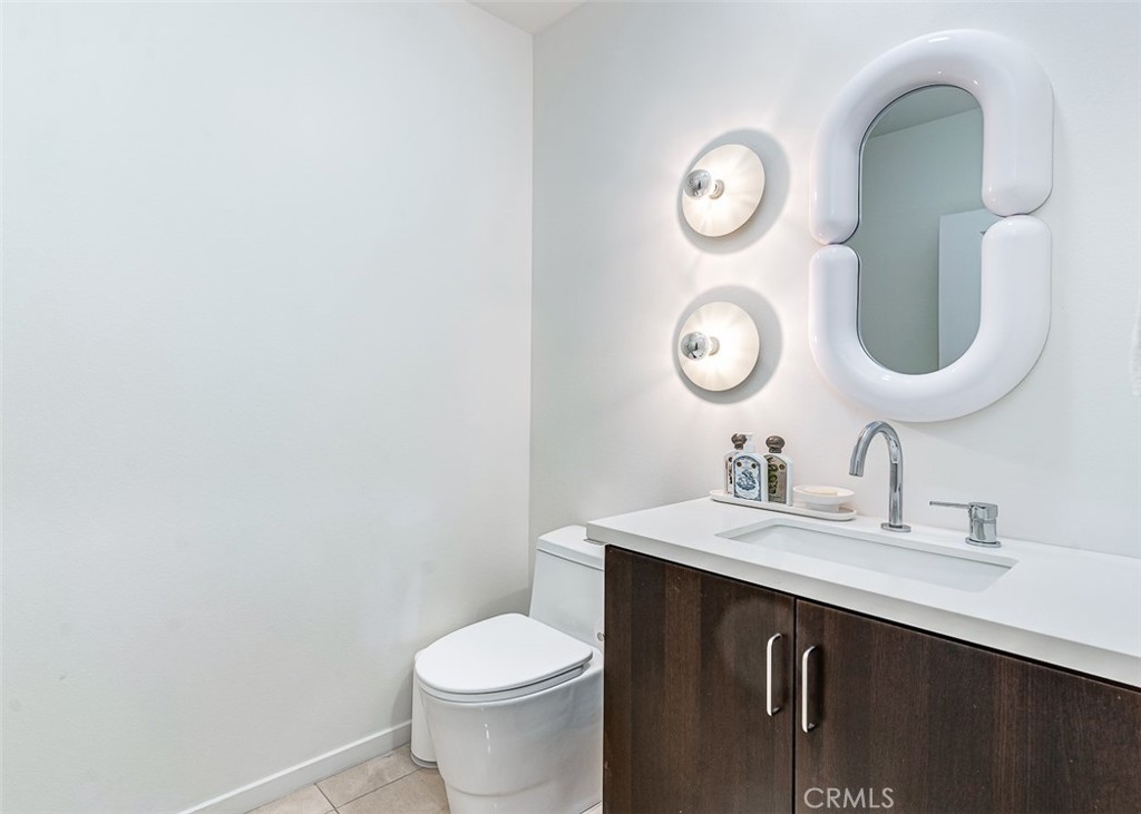 21 Gramercy, Unit 306 Irvine, CA 92612 - Photo 21 of 46 a bathroom with a toilet sink vanity and mirror