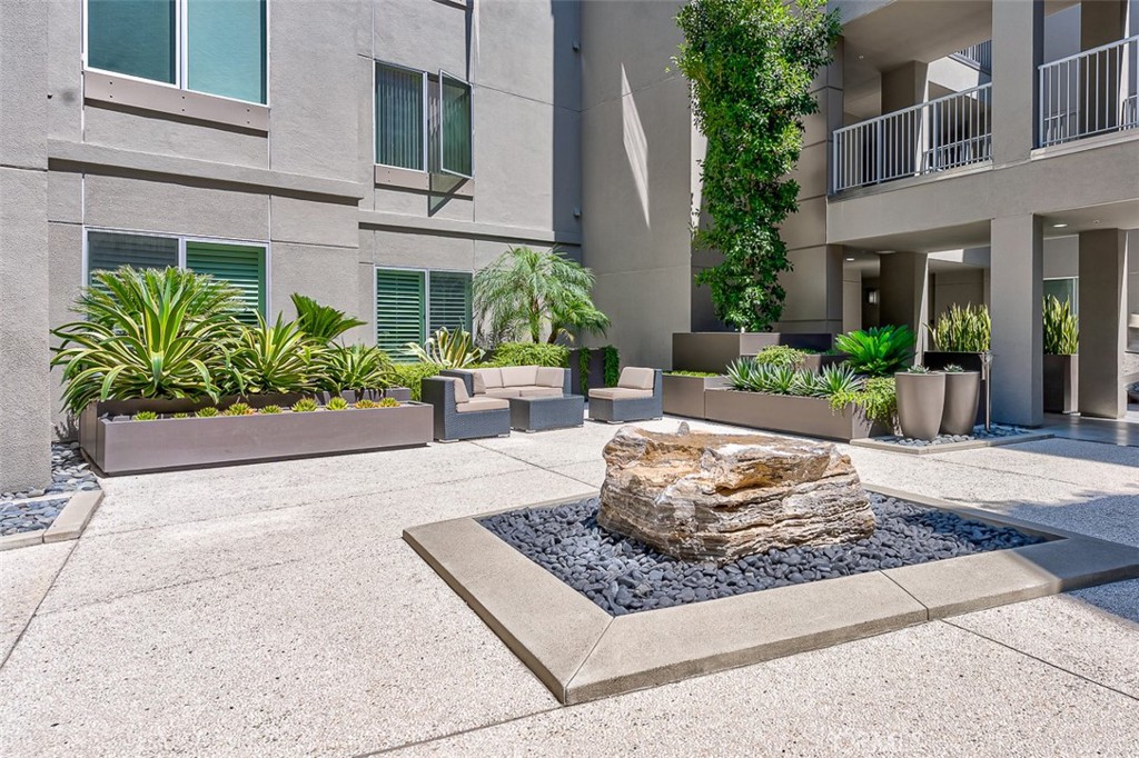 21 Gramercy, Unit 306 Irvine, CA 92612 - Photo 23 of 46 a view of a house with potted plants and more windows