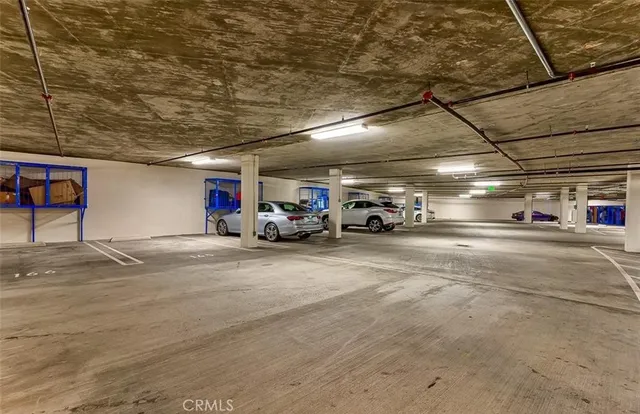 a view of a hallway with wooden floor and a living room