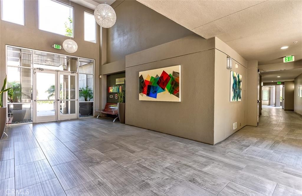 21 Gramercy, Unit 306 Irvine, CA 92612 - Photo 28 of 46 a view of a hallway with wooden floor and a living room