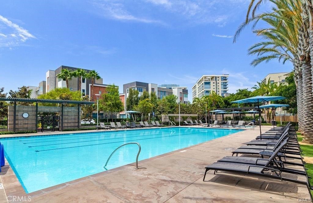 21 Gramercy, Unit 306 Irvine, CA 92612 - Photo 36 of 46 a view of a swimming pool with a chairs and table in the patio