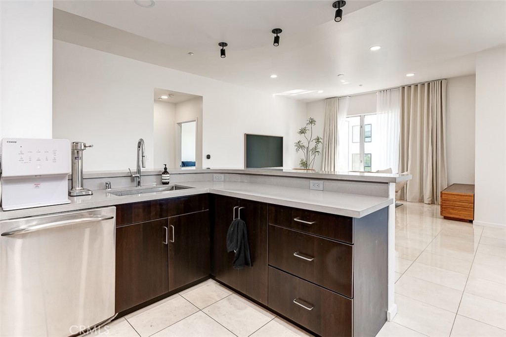 21 Gramercy, Unit 306 Irvine, CA 92612 - Photo 4 of 46 a kitchen with a sink stove and cabinets