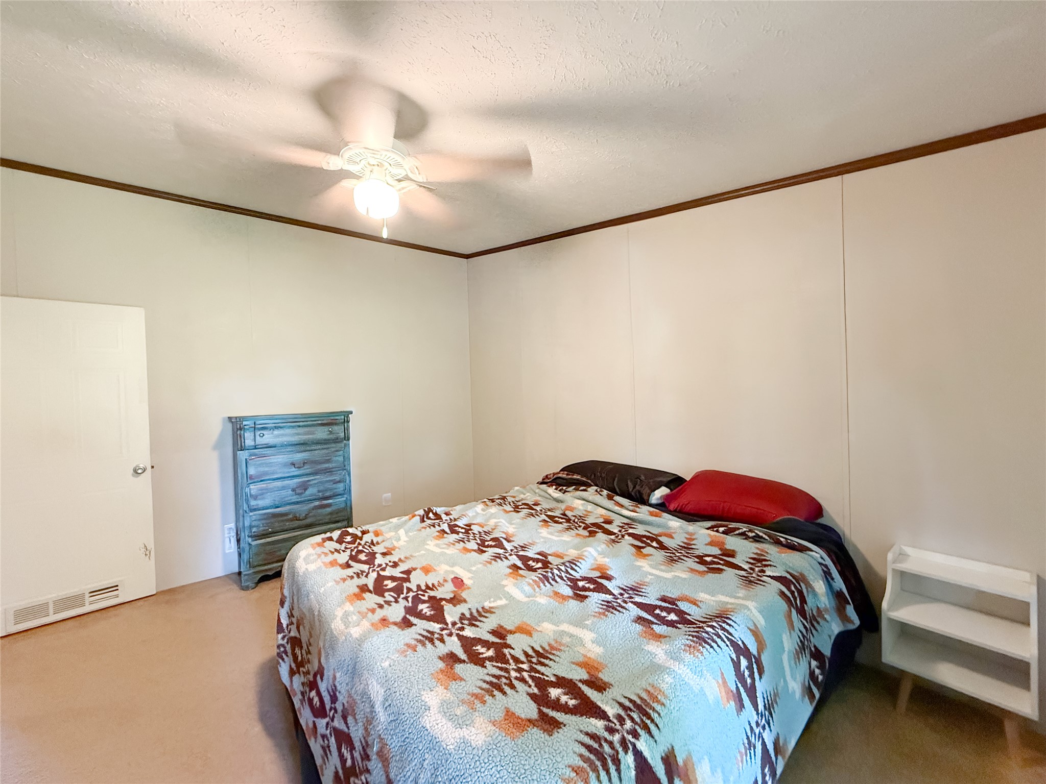 845 Caldwell Street Lexington, TX 78947 - Photo 13 of 39 Bedroom featuring light carpet, crown molding, and ceiling fan