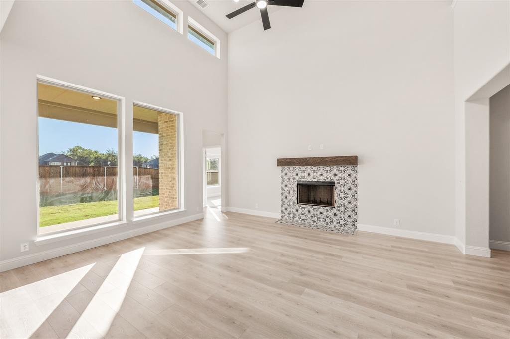 38 Osprey Street Joshua, TX 76058 - Photo 12 of 37 a view of an empty room with a window and wooden floor