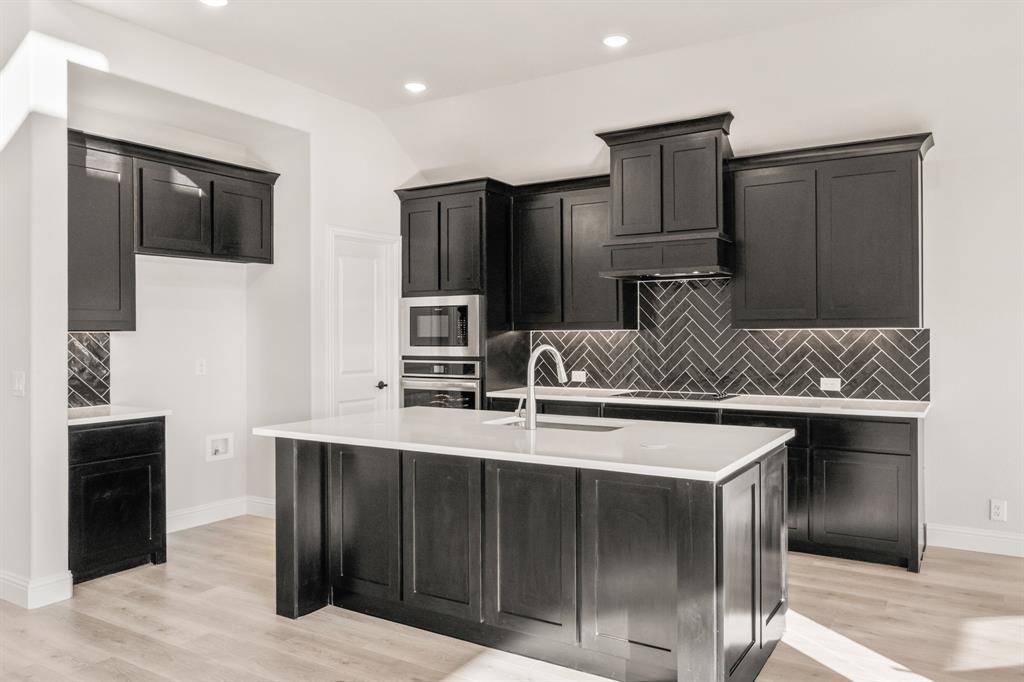 38 Osprey Street Joshua, TX 76058 - Photo 15 of 37 a kitchen with stainless steel appliances a sink and a refrigerator