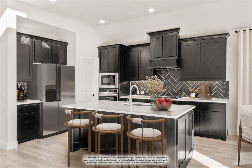 38 Osprey Street Joshua, TX 76058 - Photo 16 of 37 a kitchen with stainless steel appliances granite countertop a sink and a refrigerator