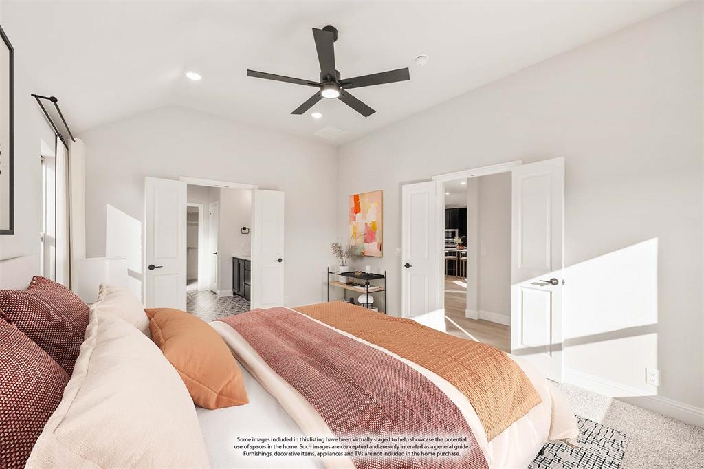 38 Osprey Street Joshua, TX 76058 - Photo 23 of 37 a bedroom with a large bed and a chandelier