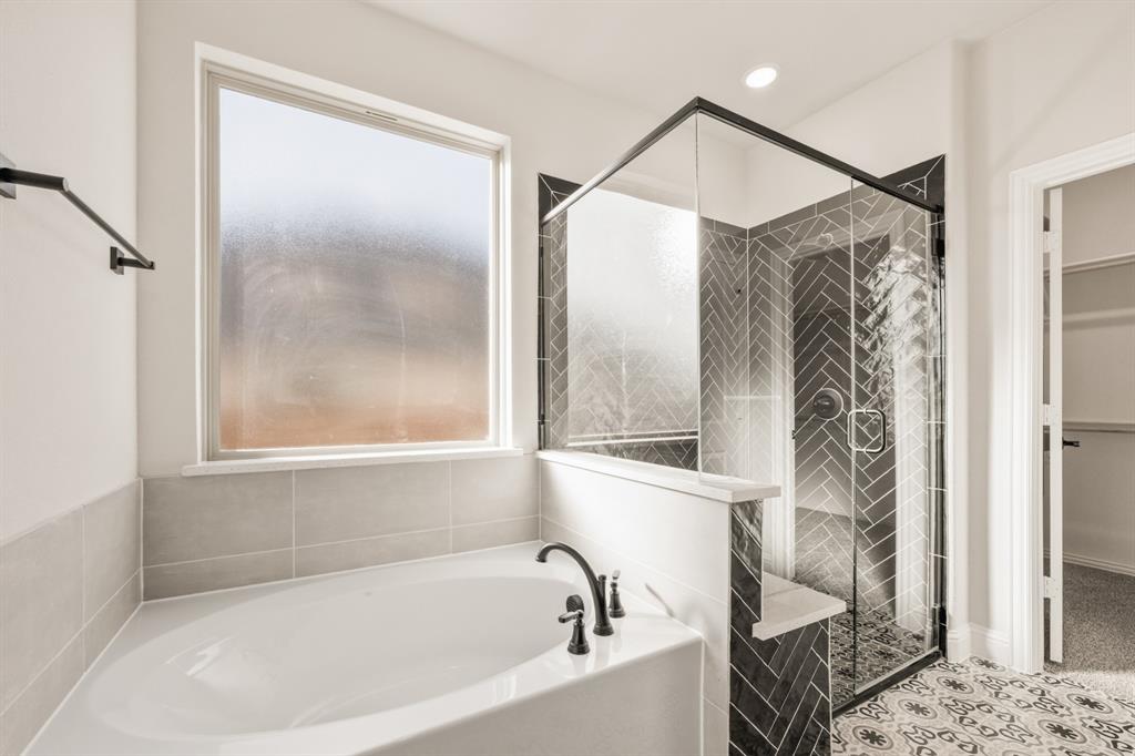 38 Osprey Street Joshua, TX 76058 - Photo 25 of 37 a bathroom with a bathtub and a shower