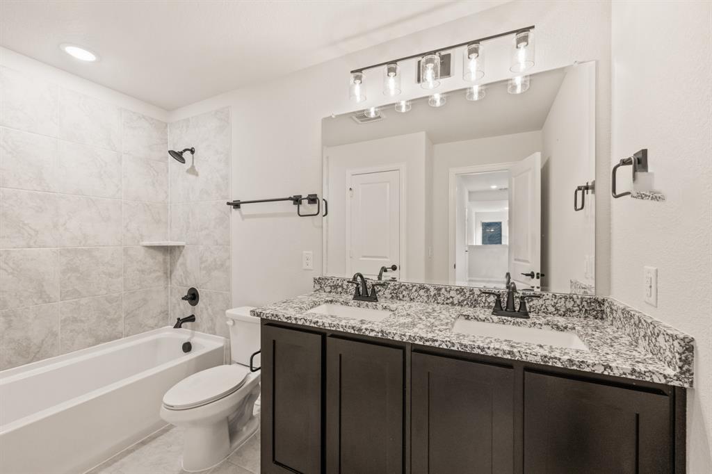 38 Osprey Street Joshua, TX 76058 - Photo 33 of 37 a bathroom with a granite countertop sink toilet and shower