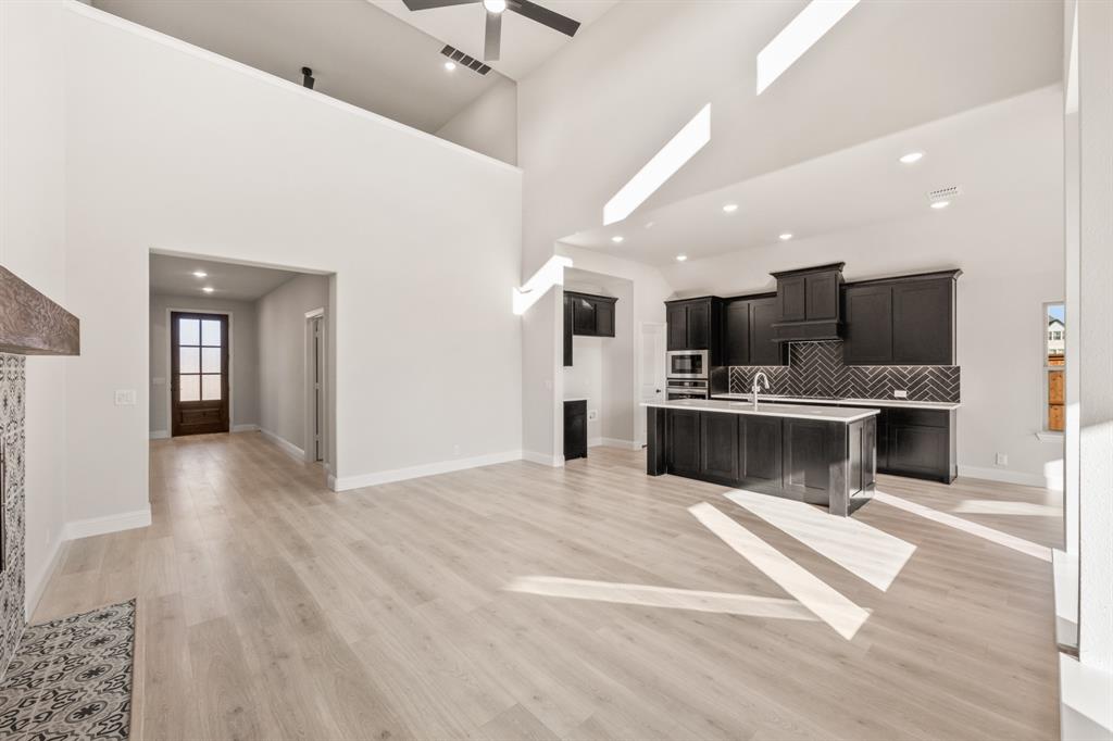 38 Osprey Street Joshua, TX 76058 - Photo 10 of 37 a view of kitchen with kitchen island a sink stainless steel appliances and cabinets