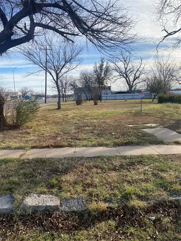 a view of yard with large trees