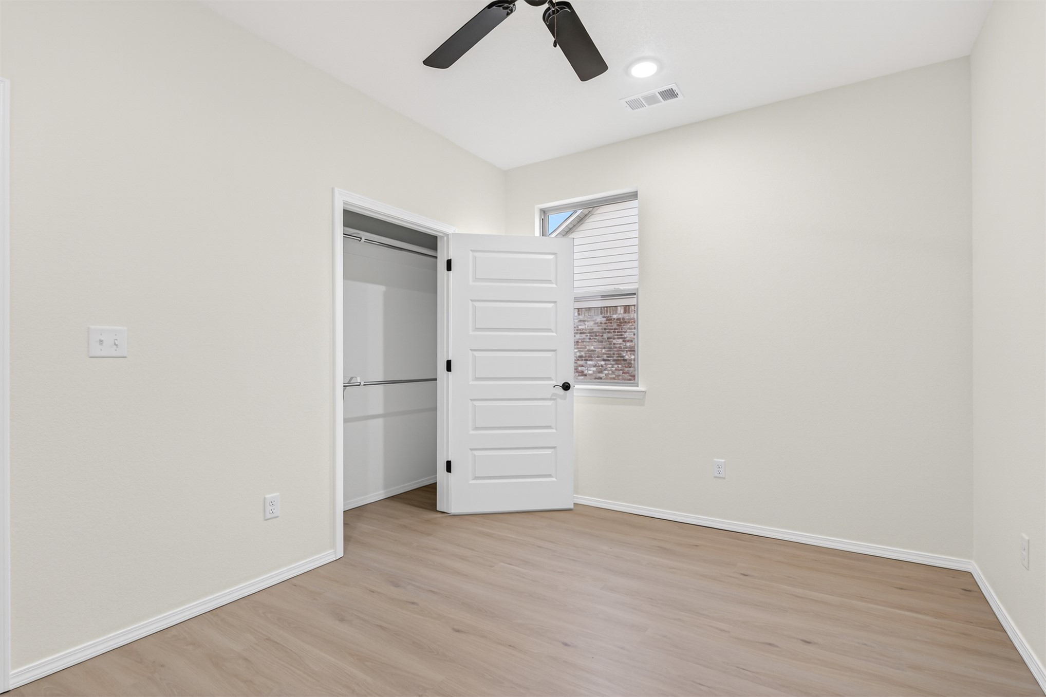 124 Countryside Way Pocola, OK 74902 - Photo 16 of 39 Wood-finish flooring, white paneled door, black ceiling fan, recessed lighting, and a closet with a built-in hanging rod