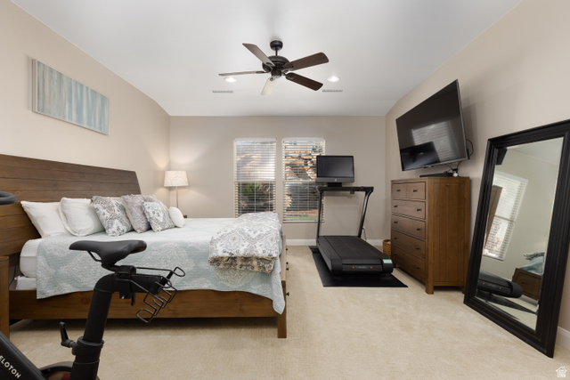 1257 West 2320 South St. George, UT 84770 - Photo 18 of 55 Spacious room featuring a wood-finish bed frame, neutral-toned carpeting, and a ceiling fan with integrated lighting