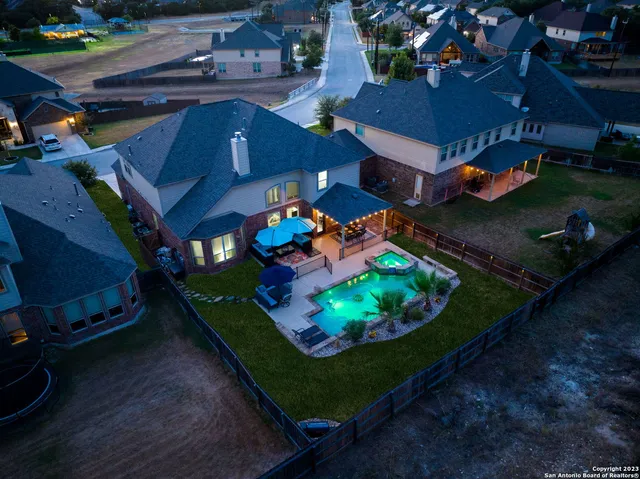 an aerial view of a house with a yard