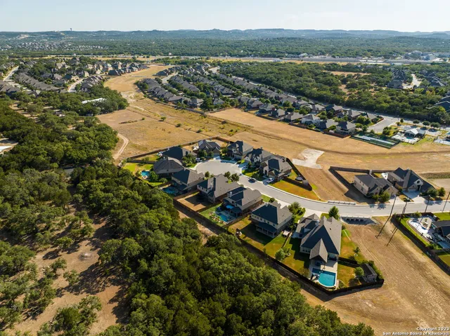 a view of a hallway with stairs and a door