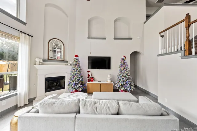 a large kitchen with kitchen island a large counter top space a sink a stove and cabinets