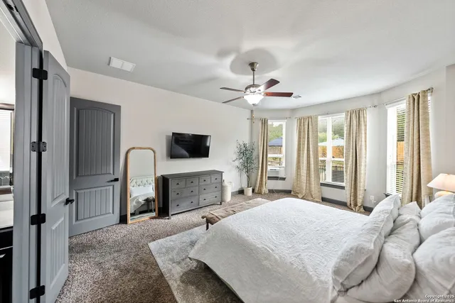 a bathroom with a tub a sink and a large mirror