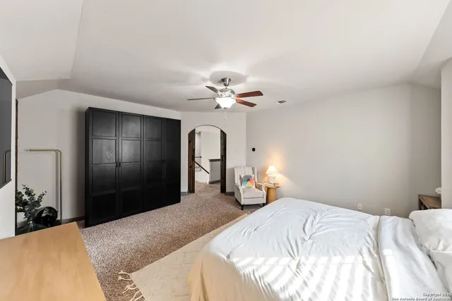 a bedroom with a bed and a chandelier