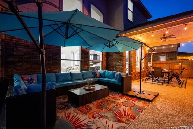 a view of a patio with swimming pool table and chairs