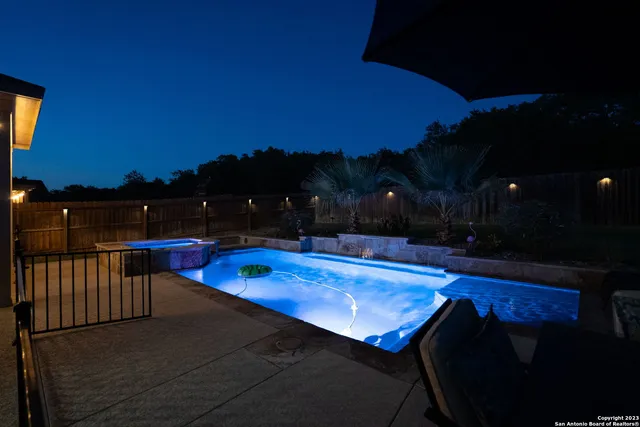 an aerial view of a house with a yard and lake view