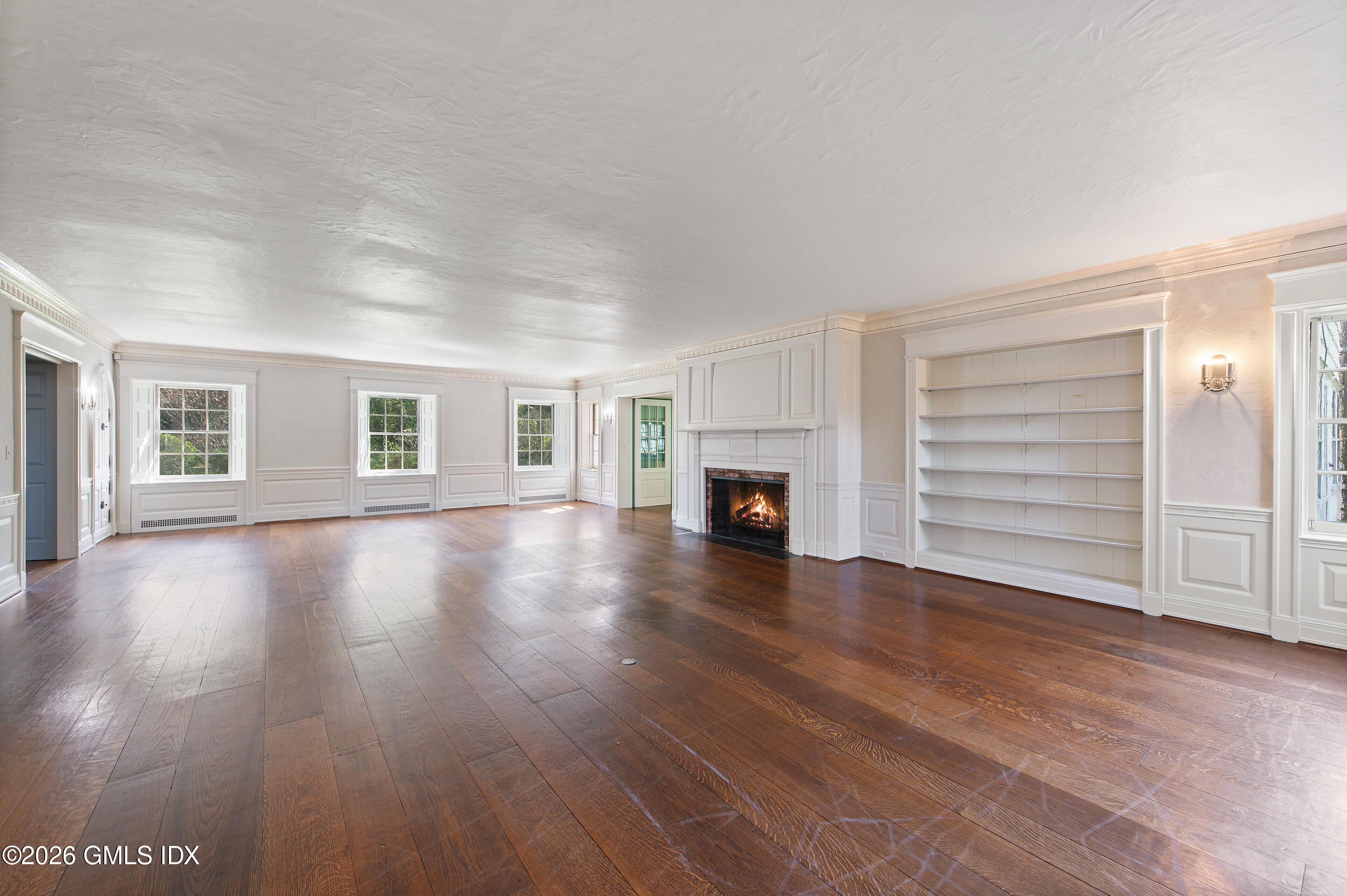 122 Round Hill Road Greenwich, CT 06831 - Photo 6 of 37 a view of empty room with a fireplace and wooden floor